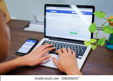 Bangkok-Thailand April 17 ,2018:close Up Teenager Man Hand Typing Keyboard On Laptop For Log In Or Sign Up Facebook Application.social Media Addiction Concept.