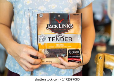 Bangkok/Thailand - August 10 2019 : Bag Of Jack Link's Beef Jerky In Teriyaki Flavor On Asian Woman Hands At Home.