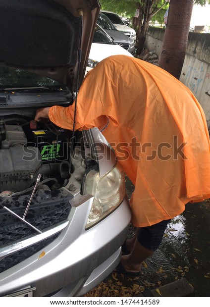 BANGKOK,THAILAND - AUGUST 9,2019 :\
Mechanic to change the car battery at\
bangkok,Thailand.