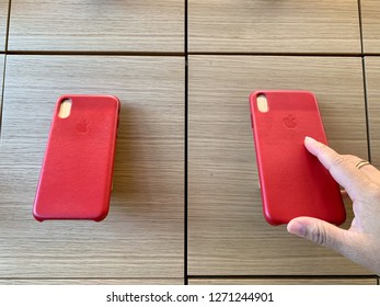 Bangkok,THAILAND -JANUARY  1,2019:Apple Iphone Red Cases Hold On Wall Show Case With Customer Hand At New Apple Store  Opening Shop At The Iconsiam Department Store At Thailand