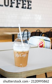 BANGKOK,THAILAND - JANUARY 20,2022 : Mcdonald's Coffee Cup On Wooden Table At McDonald's Restaurant.