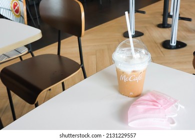 BANGKOK,THAILAND - JANUARY 20,2022 : Mcdonald's Coffee Cup On Wooden Table At McDonald's Restaurant.