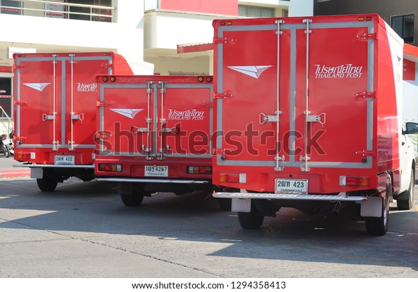 Bangkok/Thailand : January 24,2019 : Three red post\
trucks, vehicles for mail delivery parking at a branch of Thailand\
Post Office. 
