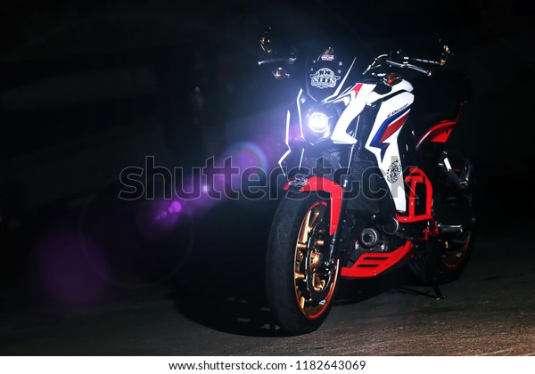 Bangkok,Thailand - July\
16 , 2017 : Motorcycle at the parking lot in the night with flare\
light of the front\
light.