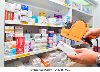 Bangkok,Thailand -July 22, 2019 : Hand Of The Pharmacist Using Yellow Labeling Gun For Sticking Price Label Of Medicine In Pharmacy Drugstore