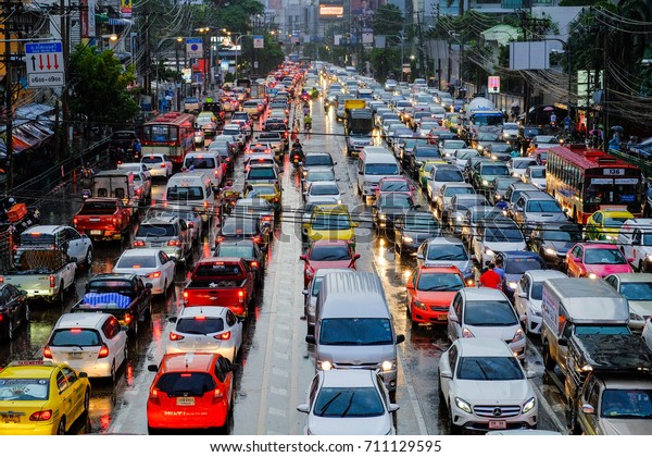 Bangkok-Thailand JUN 20 2017: Traffic jams on\
Asoke-Sukhumvit Intersection, while rain in the evenings after\
work, Asoke - Sukhumvit road is one of the most dense traffic areas\
in Bangkok.\
