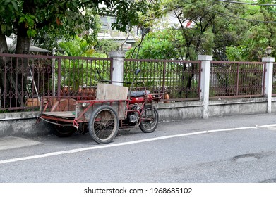 Bangkok,Thailand - May 4, 2021 : Freight tricycles parking in slum community in Thailand.Red Car for business purchase antiques and Thai people call "Saleng"