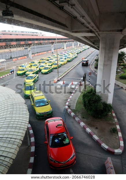 Bangkok,Thailand - October30,2021 - Taxi queue\
lines waiting for passengers arrival in front of Don Mueang\
International Airport (DMK) secondary hub low-cost domestic and\
international\
flights