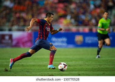 BANGKOK,THAILAND-AUGUST 07:	Alexis Sanchez of FC Barcelona run with  the ball during the international friendly match Thailand XI and FC Barcelona at Rajamangala Stadium on August 7,2013 in,Thailand.