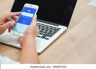 Bangkok,Thailand-August 6,2017 : Close Up Employee Woman Log In Facebook Account On Smartphone Iphone Devices For Playing Or Connecting Social Media Application Concept