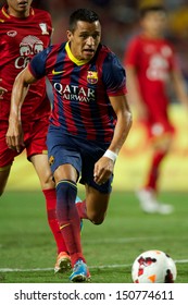 BANGKOK,THAILAND-AUGUST07:Alexis Sanchez of FC Barcelona run with the ball during the international friendly match Thailand XI and FC Barcelona at Rajamangala Stadium on August 7,2013 in,Thailand.