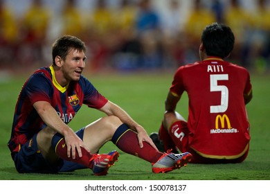 BANGKOK,THAILAND-AUGUST07:Lionel Messi (L) Of FC Barcelona Reacts  During The International Friendly Match Between Thailand XI And FC Barcelona At Rajamangala Stadium On August 7,2013 In,Thailand.