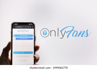 BANGKOK,THAILAND-JUNE 29: View of The Hand Holding a Mobilephone with Onlyfans Logo on the Screen Against Onlyfans Logo Background on June 29,2021