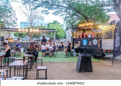 BANGKOK,THAILAND-March 2019-People Buying, Eating Food And Drinks At Outdoor Street Food Night Market In A Park. Market Stalls. Outdoor Market. Food Event. Food Fair. Festival. Flea Market. Bazaar. 