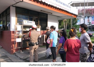 Bangkok/Thailand-May23,2020:Thai People Wear Face Masks And Keep Social Distancing Waiting To Receive Food From Police At Police Box.Police Offer Free Food For People During Spreading Of Coronavirus.