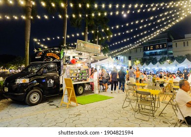 BANGKOK,THAILAND-Nov2020-People walking, buying, sitting and eating at outdoor street food night market. Market stalls. Outdoor market. Food Event. Food Fair. Festival. Flea Market. Festive.Food Truck