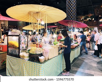 
BANGKOK,THAILAND-November 2019-People And Tourist Walking, Buying And Shopping At ICON Indoor Street Food Night Market. Market Stalls. Outdoor Market. Food Event. Food Fair. Festival. Flea Market.