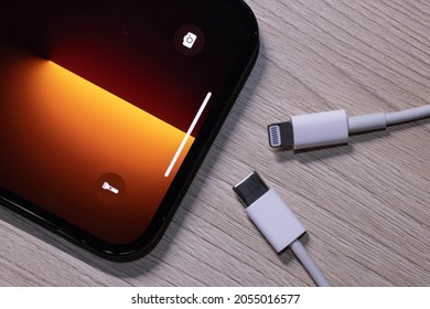 BANGKOK,THAILAND-OCTOBER 9: Apple Iphone 13 Pro Max with Lighting and Usb-c Cable Charger on October 9,2021. EU try to Forced Apple Iphone to Use Usb-c Instead of Lighting Cable in the Nearly Future