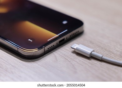 BANGKOK,THAILAND-OCTOBER 9: View of Apple Iphone 13 Pro Max with Lighting Cable Charger on October 9,2021. EU try to Forced Apple Iphone to Use Usb-c Instead of Lighting Cable in the Nearly Future