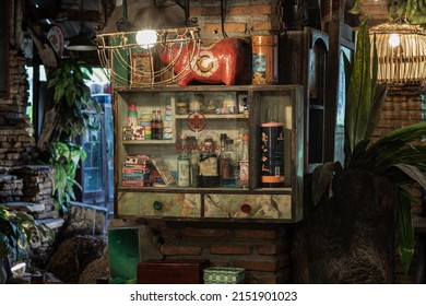 Bangkok,Thai,May 01,2022 : Vintage medicine bottles and Antique collectibles sitting on a store shelf in Cabinet for old wooden storage of medicine to Decorate the interior of country-style house.