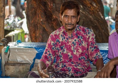 Bangladesh, Rangpur- August 31, 2021. An Idle Poor Man Is Sitting In The Local Market Wearing Dirty Clothes. The Background Blur