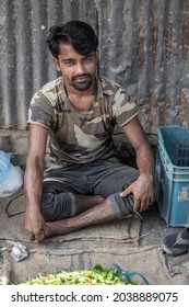 Bangladesh, Rangpur- August 31, 2021. An Idle Poor Man Is Sitting In The Local Market Wearing Dirty Clothes. The Background Blur