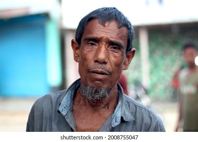 Bangladesh, Rangpur- July 12, 2021. An Old Man Standing On The Street With Upset. His Behind Background Blur.