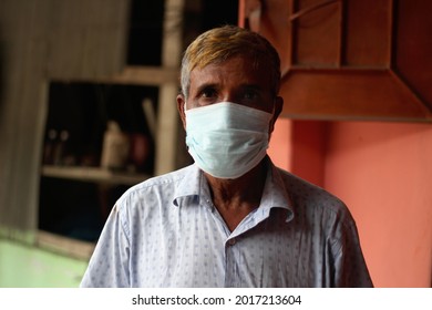 Bangladesh, Rangpur- July 13, 2021. An Old Man Standing Wearing A Mask And His Behind Background Blur