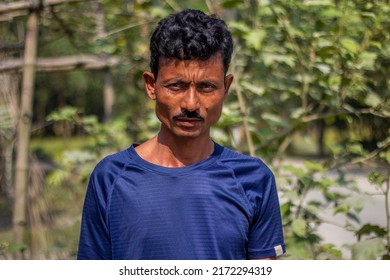 Bangladesh, Rangpur- November 14, 2021. A slender man is standing wearing a blue T-shirt and the background blur