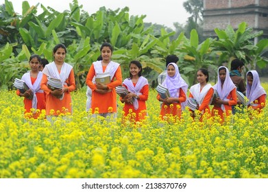 Bangladeshi Village student are going to school in the muster field with textbooks in Manikganj District outskirts of Dhaka, Bangladesh, on January 1, 2015