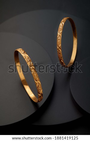 Bangle on black round shape background and grain effect