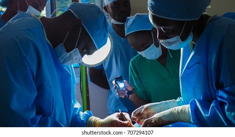 Bangou, Cameroon - July 9, 2016: Surgeons Operate On A Patient At A Mobile Hospital In Cameroon While Medical Students Observe.