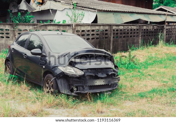 BANGSAEN THAI 2018 Close up front car crash to body Wait\
fix service \
parking on lawn and tree back side garage blurred\
background.for    \
automobile transport and automotive\
illustrative editrial 