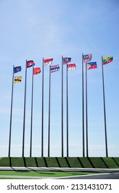 BANGSAEN, THAILAND - 19 FEB : Group of nation flags (ASEAN) with blue sky background on 19 February 2022 in Bangsaen beach, Chonburi, Thailand