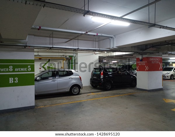 bangsar /\
malaysia - june 17 2019 : underground parking . basement carpark.\
image contain noise due to low light.\
-image
