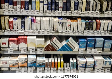 Banja Luka BiH, 10 March 2020: Cigarette Display Rack For Sale In Market. Cigar Boxes On Shelves In Supermarket. Cigarettes On Sale In Duty Free Shop. Cigarette Packages With Warning In Tobacco Store