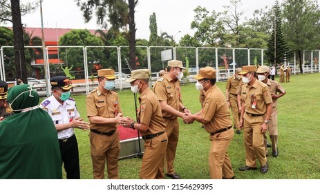 Banjarbaru, Indonesia - May 9, 2022: Indonesian civil servants shake hands during the ceremony after the long Eid al-Fitr holiday