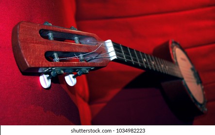 banjo closeup on red couch