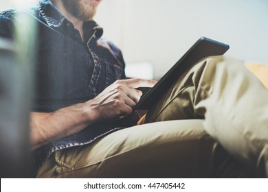 Bank Account Manager Reading Business News Modern Interior Design Loft Office.Man Relax Vintage Sofa,Use Contemporary Tablet,share Information.Blurred Background.New Startup Idea Process.Closeup