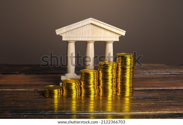 Bank building and increasing stacks of coins.\
Profitability of deposits and favorable rates for depositors,\
loyalty programs. Income growth. Increasing taxes collected.\
Budgeting. Monetary\
policy.
