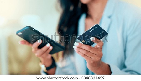Bank card data put in phone by a lady who does internet banking by typing on her mobile to make an online credit payment. Young woman texting on her phone to send money via an ewallet transaction