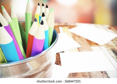 Bank with colored pencils on the wooden table - Shutterstock ID 368447201