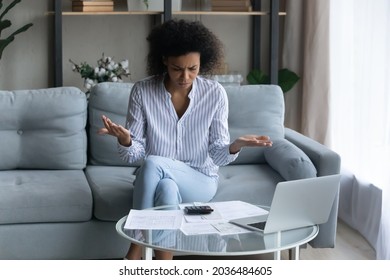 Bank documents do not balance. Concerned afro american female review financial papers at home office dissatisfied with mistake bad result. Confused young black woman think on unexpected debt problem