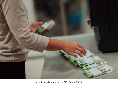 Bank Employees Holding A Pile Of Paper Banknotes While Sorting And Counting Inside Bank Vault. Large Amounts Of Money In The Bank