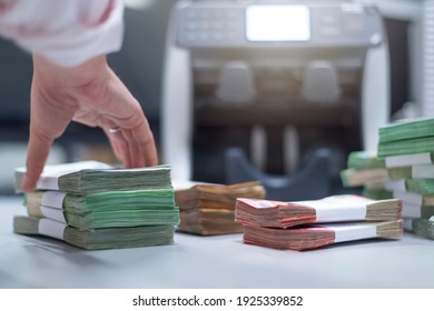 Bank Employees Sorting And Counting Money Inside Bank Vault. Large Amounts Of Money In The Bank.