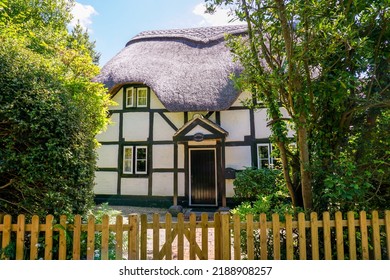 Bank, Hampshire, England - 06.14.2022 - Small Country Cottage With Traditional Straw Thatched Roof. Picturesque Timber Framed White Cottage In The New Forest National Park UK. Rural House