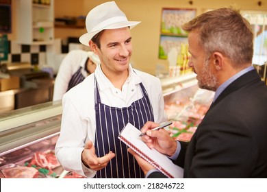 Bank Manager Meeting With Owner Of Butchers Shop