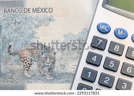 Bank of mexico, Jaguar symbol on one thousand pesos banknote and calculator, Financial calculation concept
