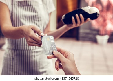 Bank Operations. Close Up Of A Debit Card Being Used For Payment In The Cafe