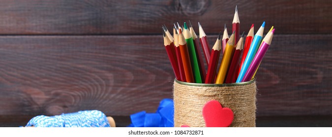 Bank For Pencils With Hearts Wrapped With String On A Wooden Table. Handmade. Banner.  Pencil Holder.